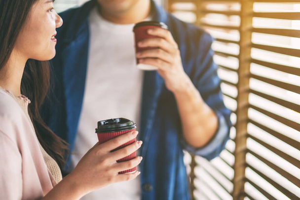 A man and a woman drinking coffee together  - Photo, Image