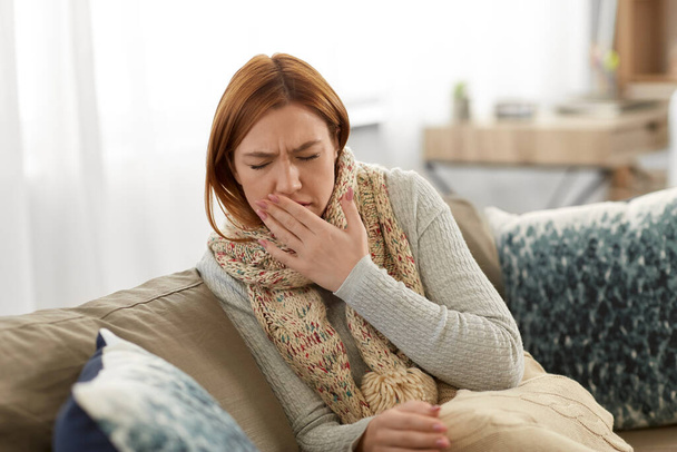 sick woman in scarf coughing at home - Foto, Imagen