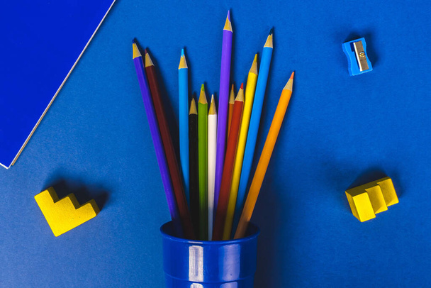 colorful pens on a pot with a blue background - Photo, Image