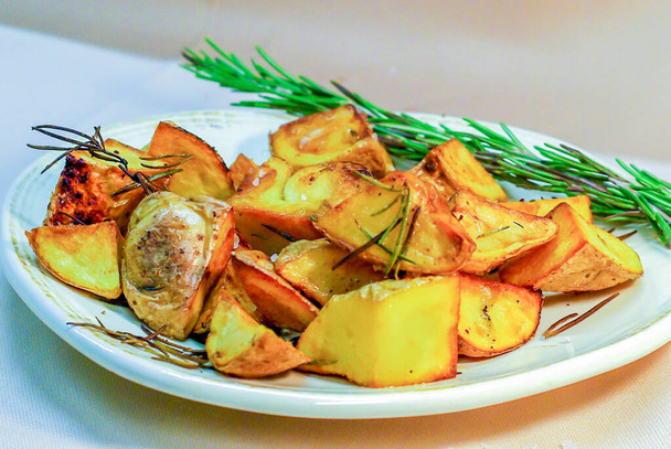 roast potatoes in the oven with rosemary - Photo, Image