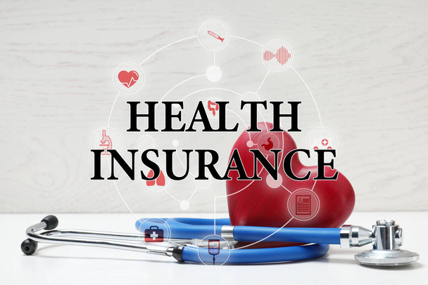 Phrase Health Insurance, stethoscope, red heart and icons on light background - Фото, зображення