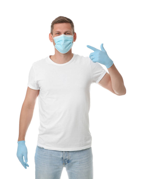 Male volunteer in mask and gloves on white background. Protective measures during coronavirus quarantine - Fotoğraf, Görsel