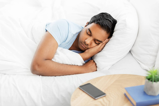 indian man sleeping in bed at home - Zdjęcie, obraz