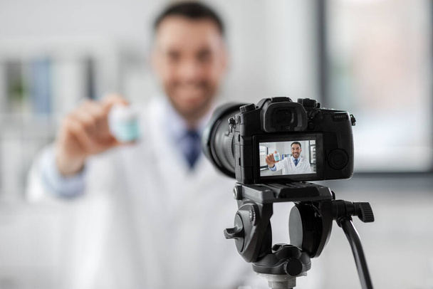 doctor with drug recording video blog at hospital - Фото, изображение