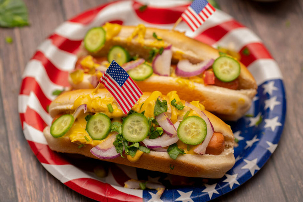 Hot dogs with pickles and the American flag toothpicks - 写真・画像