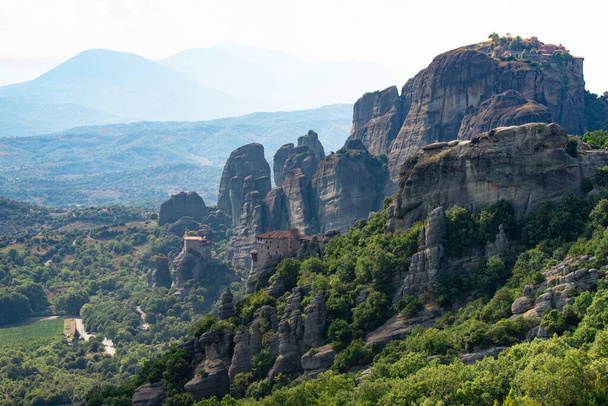 Great view of the monasteries of Meteora in Greece. Landscape with monasteries and rocks in the sunset - Zdjęcie, obraz