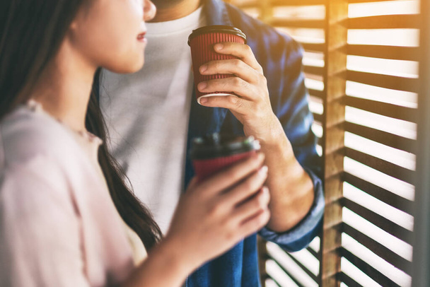 A man and a woman drinking coffee together  - Foto, Bild