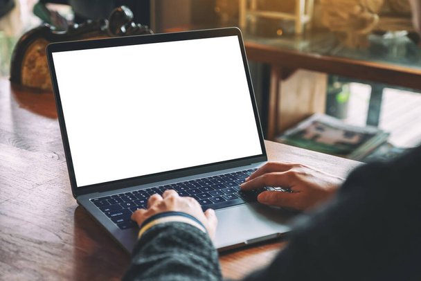 Макет зображення жінки, яка використовує і друкує на клавіатурі ноутбука з порожнім білим екраном робочого столу на дерев'яному столі
 - Фото, зображення
