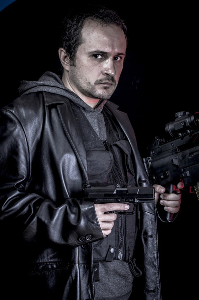 Terrorist, thief, armed man with black leather jacket, dangerous - 写真・画像
