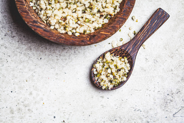Peeled hemp seeds in a wooden bowl. Hemp - superfood, antioxidant, a healthy food supplement. - Photo, image