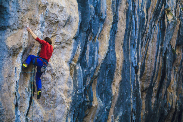 A strong man climbs a rock, Rock climbing in Turkey, Training endurance and strength, man in extreme sport, Rock climber is training in nature. - Photo, Image