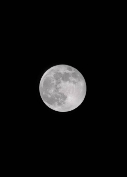 Moon glowing on black background - Photo, Image