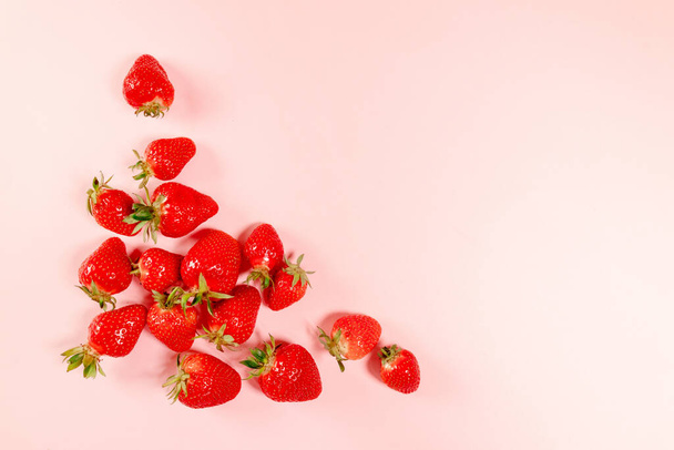 Top view organic tasty strawberries on pink background. horizontal space for text - Photo, Image