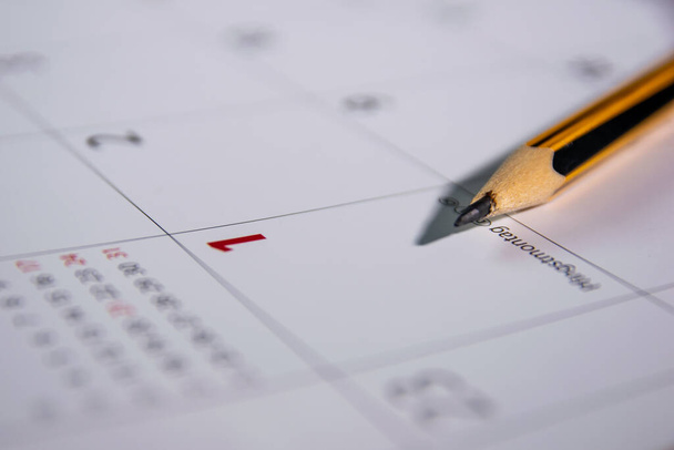 a pencil lies on an open calendar indicating the first day of the month. - Fotoğraf, Görsel