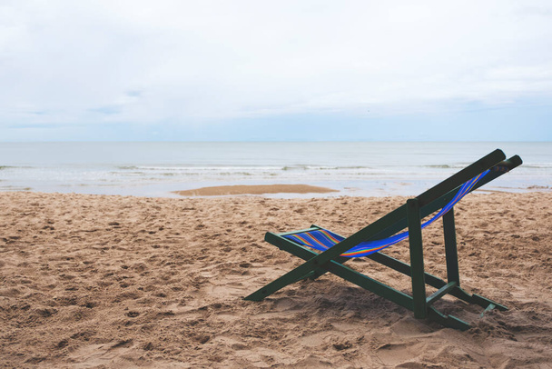 A single beach chair by the sea with blue sky background - Fotoğraf, Görsel