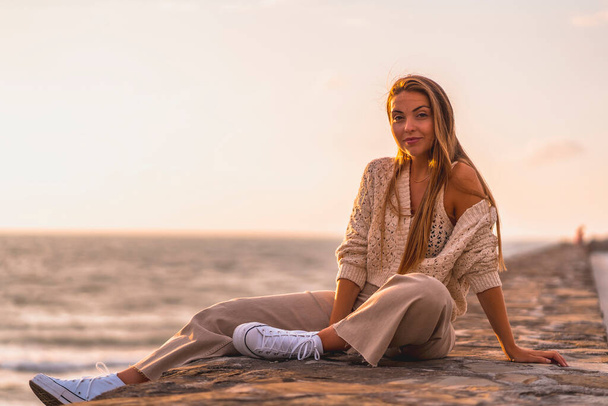 Summer lifestyle. Portrait of young woman on a beach at sunset. - Valokuva, kuva