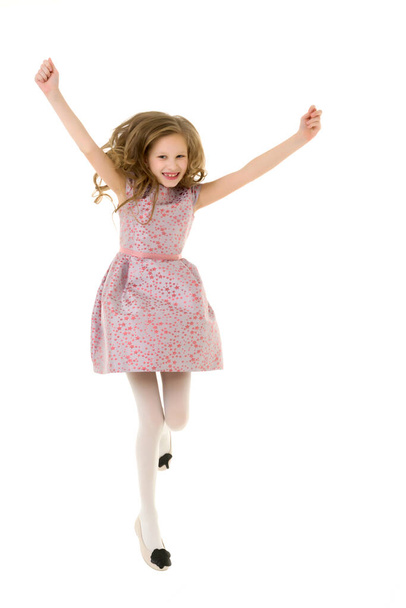 Beautiful Blonde Girl Happily Jumping with Raising Hands - Foto, afbeelding
