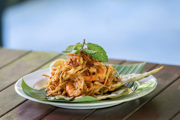 "Yum Hua Plee "is the spicy banana blossom salad from Thailand local traditional North area is shot on the wood table
. - Фото, изображение
