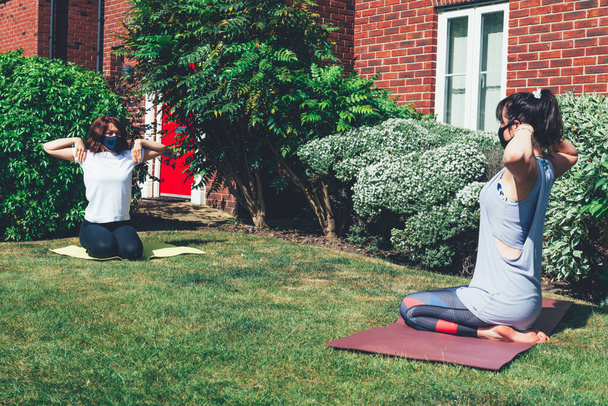 Training yoga in garden with social distance - Photo, Image