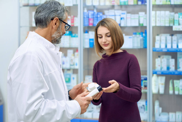 Female customer and pharmacist choosing medicine. - Foto, imagen
