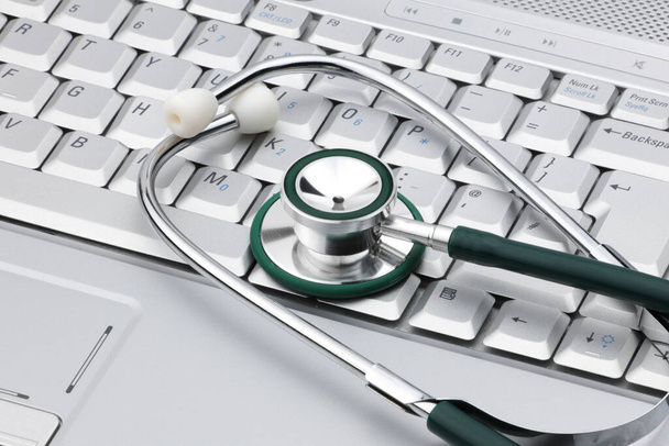 Medical stethoscope on a laptop signifying the relationship of IT and medicine - Photo, Image