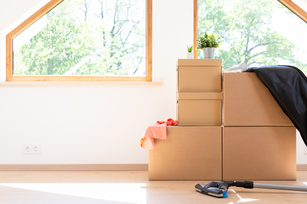 Move. Cardboard boxes for moving into a new, clean home. In a sunny day by a window in attic. - Photo, Image