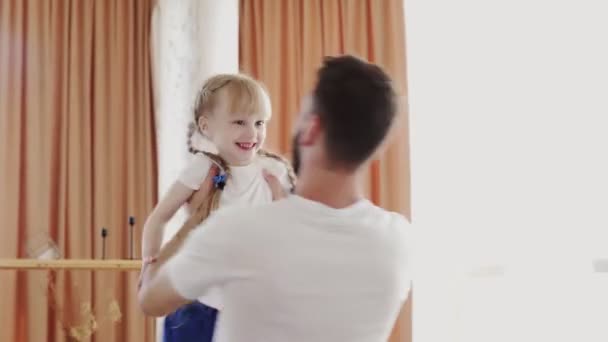 Young bearded father rotates his daughter in air rotates his daughter in air. Fathers day concept - Video, Çekim