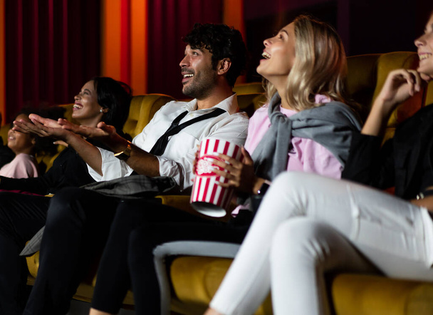 People audience watching movie in the movie theater cinema. Group recreation activity and entertainment concept. - Foto, imagen