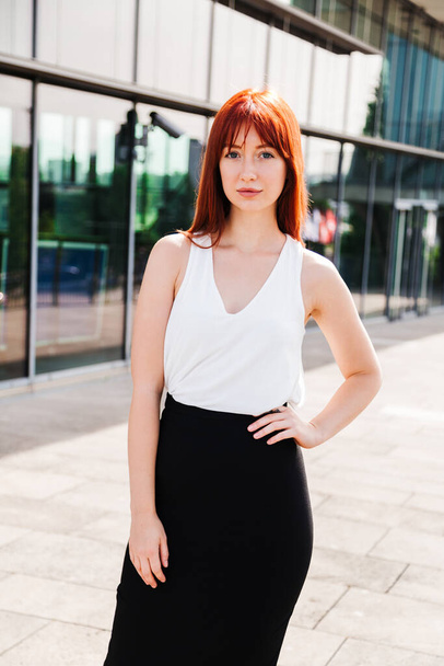 Young redhead business woman in formal outside - Фото, зображення