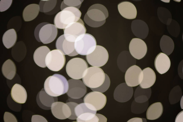 Defocused lights on the black background, optic effect - Φωτογραφία, εικόνα