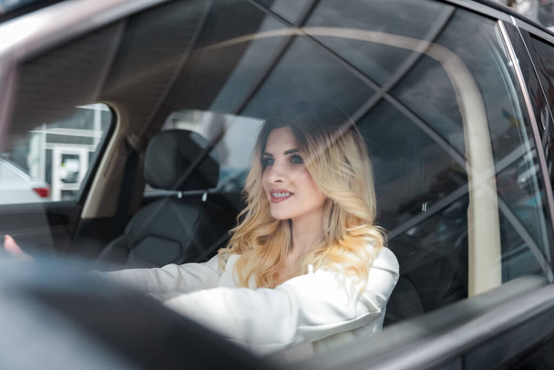 Beautiful woman driving a car - Фото, изображение