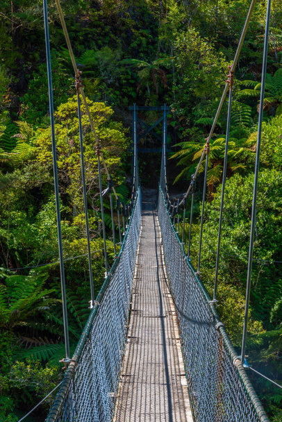 Swing bridge over Falls river at Abel Tasman national park in New Zealand - Photo, image