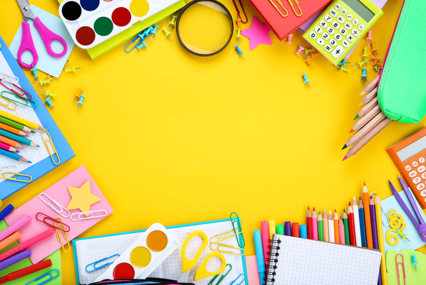 Different school supplies on yellow background - Foto, afbeelding