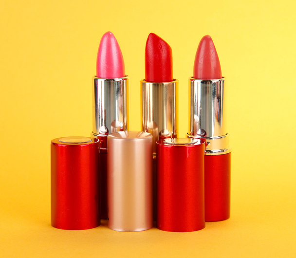 Lipsticks on yellow background - Photo, image