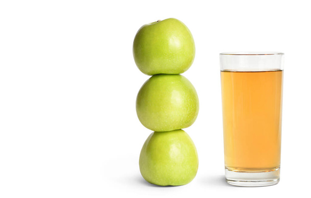 Three ripe green apples and a glass of juice on a white isolated background - Φωτογραφία, εικόνα