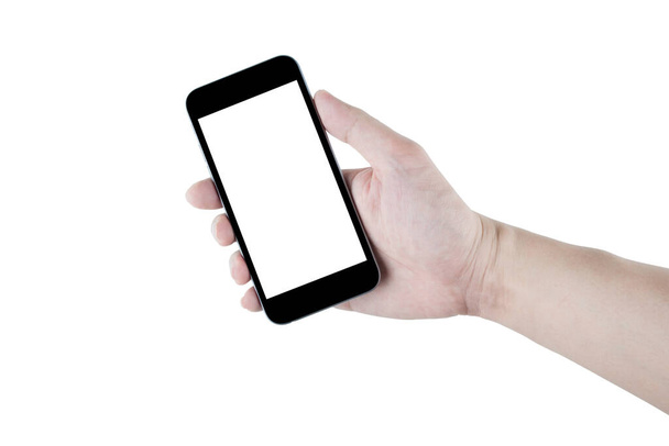 Hand is holding black smartphone, isolated on white background. Clipping path embedded. - Photo, image