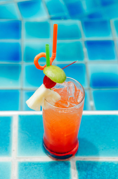 Bebida de refrigerante italiana de soco laranja ao lado da piscina, conceito de relaxamento ao ar livre de resort tropical no verão
 - Foto, Imagem