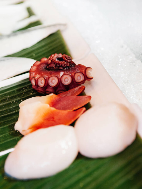 Verse zeevruchten Octopus Tako en Hokkigai stimpson surf mossel op ijs voor Japanse sushi sashimi - Foto, afbeelding