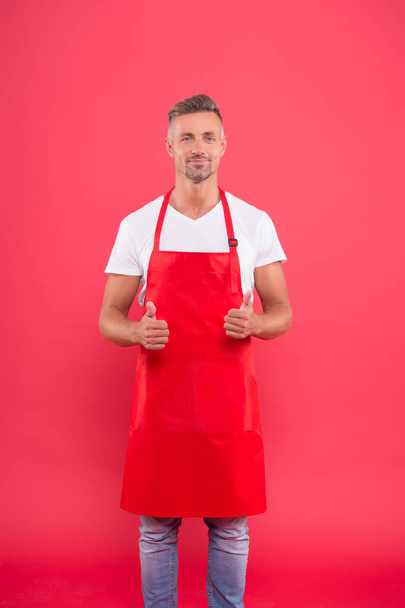 male chef cook in red apron. businessman wear apron in coffee shop. his favorite work. Portrait of handsome professional chef. smiling chef man show thumb up. professional chef wanted - Foto, imagen