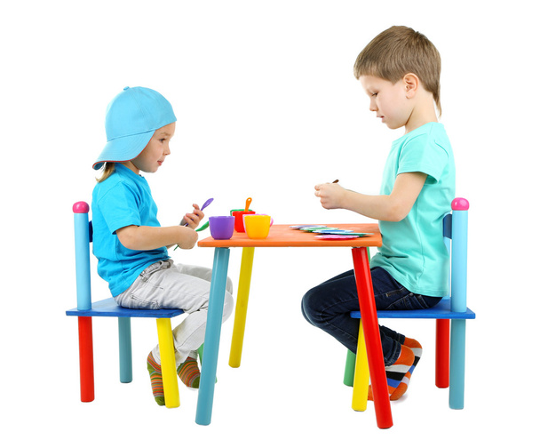 Little children playing with colorful tableware isolated on white - Valokuva, kuva