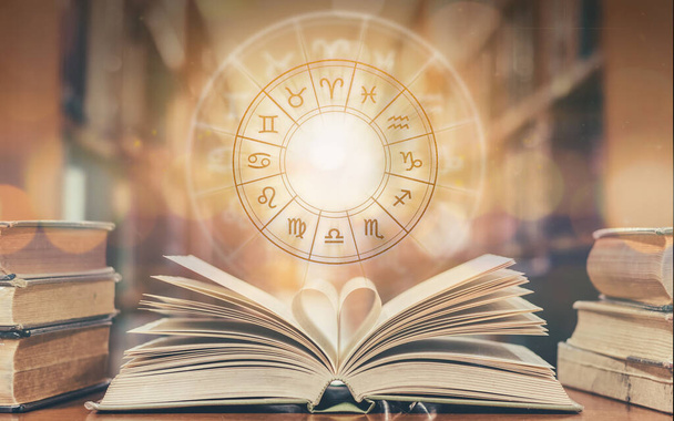 Love horoscope, zodiac sign astrology for foretell and fortune telling education study course concept with horoscopic wheel over old love story book in school library - Photo, Image