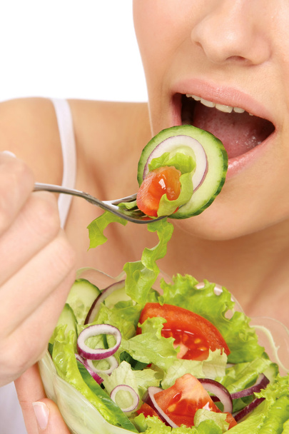 Woman is eating a salad - Photo, Image