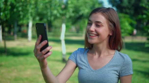 portrait woman chatting online outdoors - Felvétel, videó