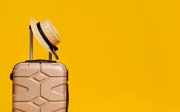 Minimalistic Photo Of Suitcase And Straw Hat Over Yellow Background - Photo, image