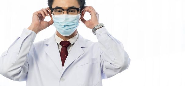 Panoramic Portrait of Asian male doctor wearing protective face mask. Healthcare Concept. Web banner crop with free copyspace. - Photo, image