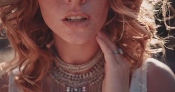 Boho redhead woman with freckles wearing silver jewelry in nature - Video