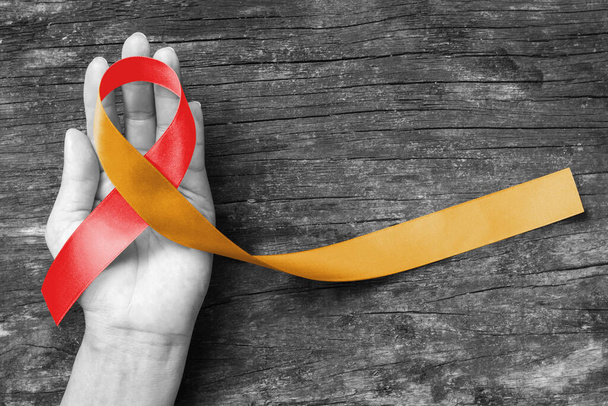 Red Gold ribbon awareness concept raising support or help people patients living with Neonatal Alloimmune Thrombocytopenia (NAIT) - Fotografie, Obrázek