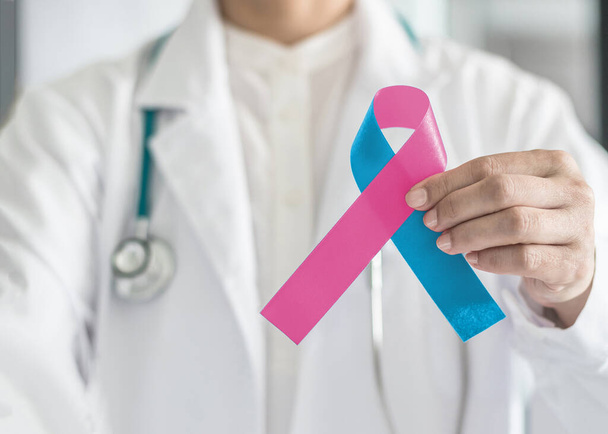 Pink blue ribbon awareness, symbolic bow color for Infant birth defect, Sudden Infant Death Syndrome (SIDS), pregnancy Loss on helping handin doctor's hand - Fotoğraf, Görsel