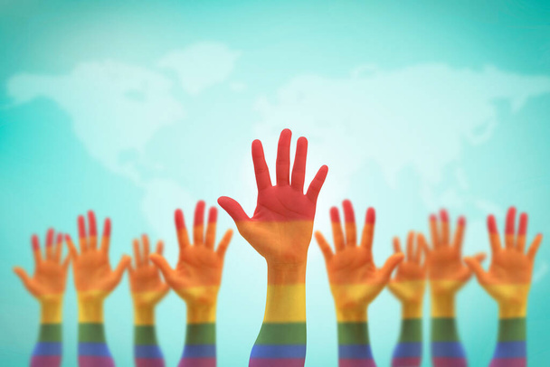 LGBT equal rights movement and gender equality concept with rainbow flag on people's hands up - Photo, Image