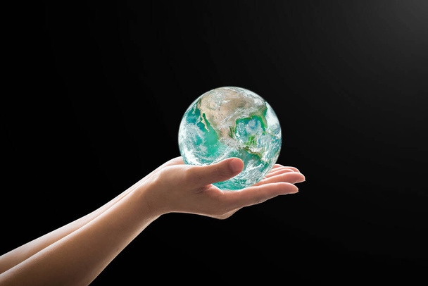 World environment concept with green earth on hand support: Στοιχεία της εικόνας από την NAS - Φωτογραφία, εικόνα